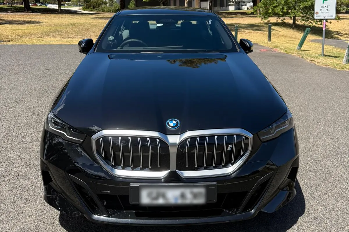 Front view of a black BMW 5 Series chauffeur car with its illuminated grille